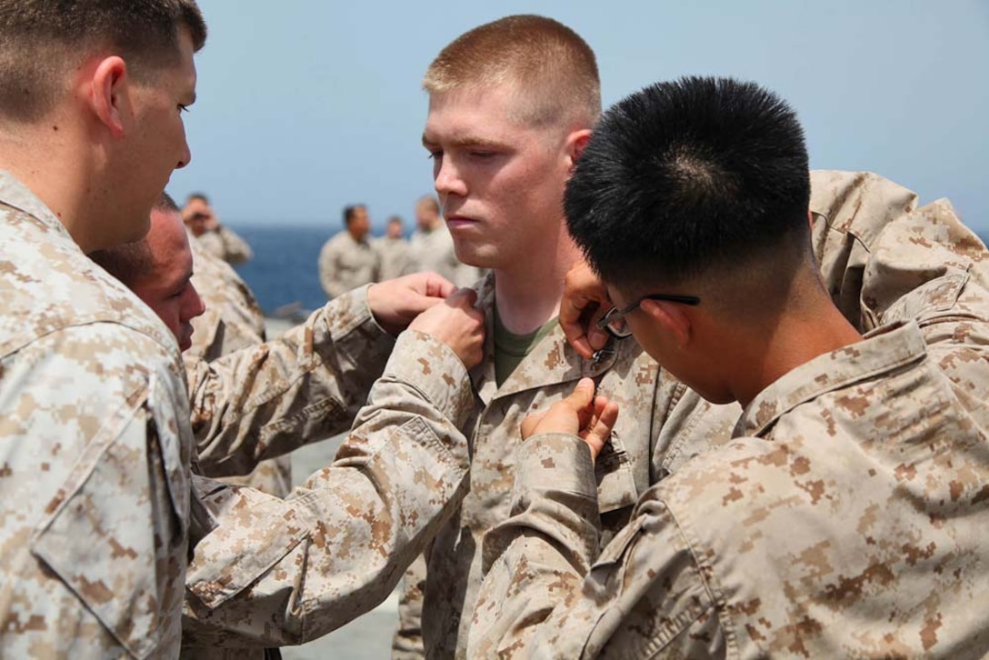Corporal Ramen Kilgo, field radio operator, 2nd Platoon, Battery B, Battalion Landing Team 3/5, 15th Marine Expeditionary Unit, is promoted to the rank of corporal aboard USS Rushmore, March 1. The 15th MEU is deployed as part of the Peleliu Amphibious Ready Group as a U.S. Central Command theater reserve force, providing support for maritime security operations and theater security cooperation efforts in the U.S. 5th Fleet area of responsibility. (U.S. Marine Corps photo by Cpl. Timothy R. Childers/ Released)
