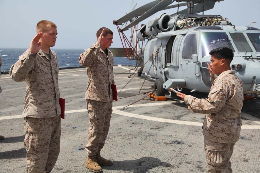 Corporal Ramen Kilgo (left), field radio operator, 2nd Platoon, Battery B, Battalion Landing Team 3/5, 15th Marine Expeditionary Unit, and Cpl. Jordan Jorgensen, an ammunition technician from the same platoon, cite the Non-Commissioned Officer's Creed after being promoted to the rank of corporal aboard USS Rushmore, March 1. The 15th MEU is deployed as part of the Peleliu Amphibious Ready Group as a U.S. Central Command theater reserve force, providing support for maritime security operations and theater security cooperation efforts in the U.S. 5th Fleet area of responsibility. (U.S. Marine Corps photo by Cpl. Timothy R. Childers/ Released)