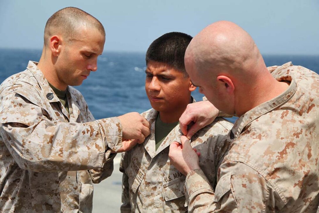 Sergeant Edgar Carachure, field artillery cannoneer, 1st Platoon, Battery B, Battalion Landing Team 3/5, 15th Marine Expeditionary Unit, is promoted to the rank of sergeant aboard USS Rushmore, March 1. The 15th MEU is deployed as part of the Peleliu Amphibious Ready Group as a U.S. Central Command theater reserve force, providing support for maritime security operations and theater security cooperation efforts in the U.S. 5th Fleet area of responsibility. (U.S. Marine Corps photo by Cpl. Timothy R. Childers/ Released)