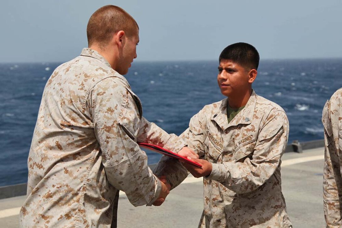 Sergeant Edgar Carachure, field artillery cannoneer, 1st Platoon, Battery B, Battalion Landing Team 3/5, 15th Marine Expeditionary Unit, is promoted to the rank of sergeant aboard USS Rushmore, March 1. The 15th MEU is deployed as part of the Peleliu Amphibious Ready Group as a U.S. Central Command theater reserve force, providing support for maritime security operations and theater security cooperation efforts in the U.S. 5th Fleet area of responsibility. (U.S. Marine Corps photo by Cpl. Timothy R. Childers/ Released)
