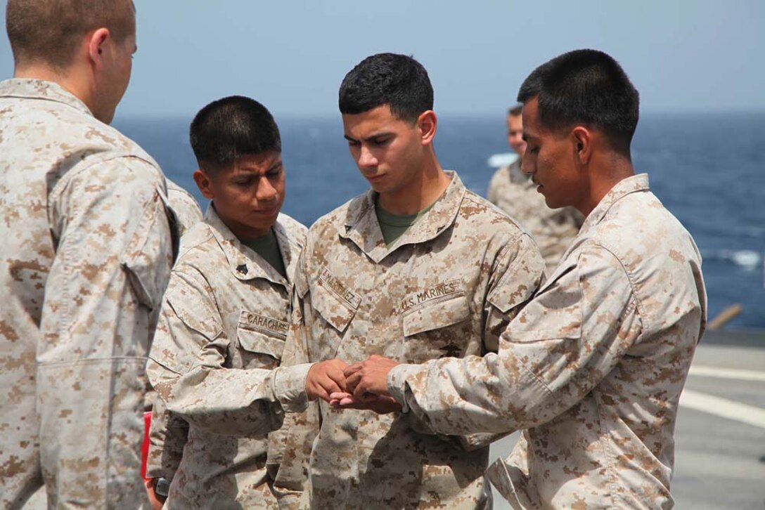 Corporal Christopher Martinez, field artillery cannoneer, 1st Platoon, Battery B, Battalion Landing Team 3/5, 15th Marine Expeditionary Unit, is promoted to the rank of corporal aboard USS Rushmore, March 1. The 15th MEU is deployed as part of the Peleliu Amphibious Ready Group as a U.S. Central Command theater reserve force, providing support for maritime security operations and theater security cooperation efforts in the U.S. 5th Fleet area of responsibility. (U.S. Marine Corps photo by Cpl. Timothy R. Childers/ Released)