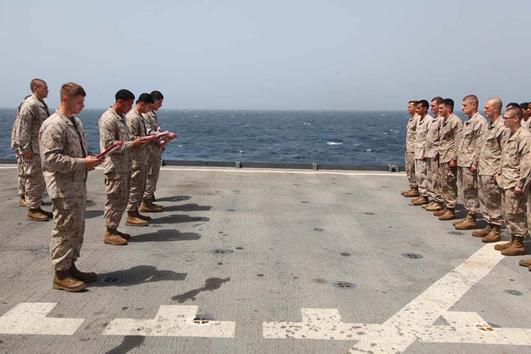 Marines assigned to 1st Platoon, Battery B, Battalion Landing Team 3/5, 15th Marine Expeditionary Unit cite the Non-Commissioned Officer's Creed after being promoted to the rank of corporal on the flight deck of USS Rushmore, March 1. The 15th MEU is deployed as part of the Peleliu Amphibious Ready Group as a U.S. Central Command theater reserve force, providing support for maritime security operations and theater security cooperation efforts in the U.S. 5th Fleet area of responsibility. (U.S. Marine Corps photo by Cpl. Timothy R. Childers/ Released)