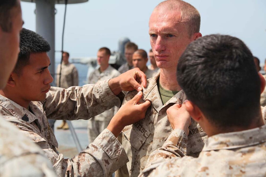 Corporal Joseph F. Bielefeldt, landing support specialist, Transportation Support Detachment, Combat Logistics Battalion 15, 15th Marine Expeditionary Unit, is promoted to the rank of corporal aboard USS Rushmore, March 1. The 15th MEU is deployed as part of the Peleliu Amphibious Ready Group as a U.S. Central Command theater reserve force, providing support for maritime security operations and theater security cooperation efforts in the U.S. 5th Fleet area of responsibility. (U.S. Marine Corps photo by Cpl. Timothy R. Childers/ Released)