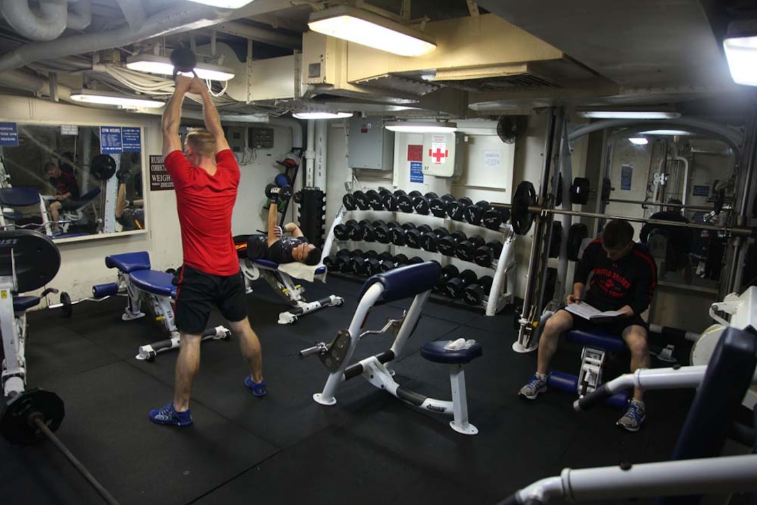 Marines assigned to the 15th Marine Expeditionary Unit work out in the weight room aboard USS Rushmore, March 2. While away, servicemembers find many ways to pass time while improving themselves and others physically, mentally and professionally. The 15th MEU is deployed as part of the Peleliu Amphibious Ready Group as a U.S. Central Command theater reserve force, providing support for maritime security operations and theater security cooperation efforts in the U.S. 5th Fleet area of responsibility. (U.S. Marine Corps photo by Cpl. Timothy R. Childers/ Released)