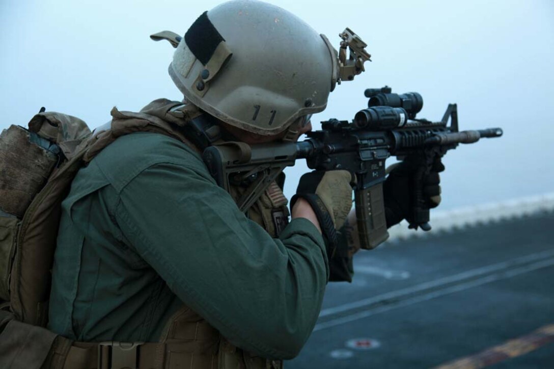 A Marine with Force Reconnaissance Platoon, Maritime Raid Force, 15th Marine Expeditionary Unit, fires at a target during a range held on the flight deck of the USS Peleliu, March 2. The 15th MEU is deployed as part of the Peleliu Amphibious Ready Group as a U.S. Central Command theater reserve force, providing support for maritime security operations and theater security cooperation efforts in the U.S. 5th Fleet area of responsibility. (U.S. Marine Corps photo by Cpl. John Robbart III/Released)