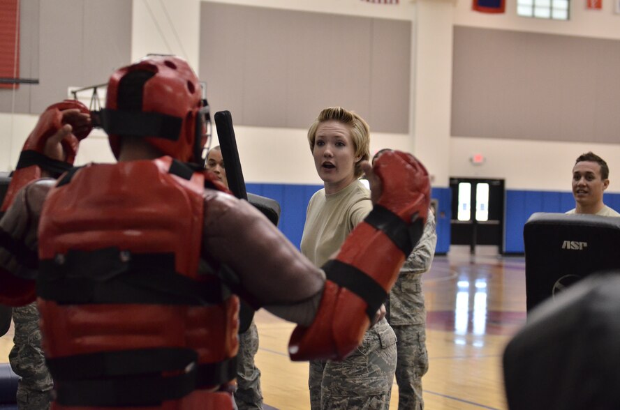 Airman 1st Class Clare Galabinski, 36th Medical Support Squadron, gives a verbal command to surrender during “Redman” training in the Coral Reef Fitness Center at Andersen Air Force Base, Guam, March 1, 2013. The training consists of less-than-lethal tactics used to gain compliance from a subject demonstrating the intent to cause serious bodily harm to oneself or others. (U.S. Air Force photo by Staff Sgt. Alexandre Montes/Released)