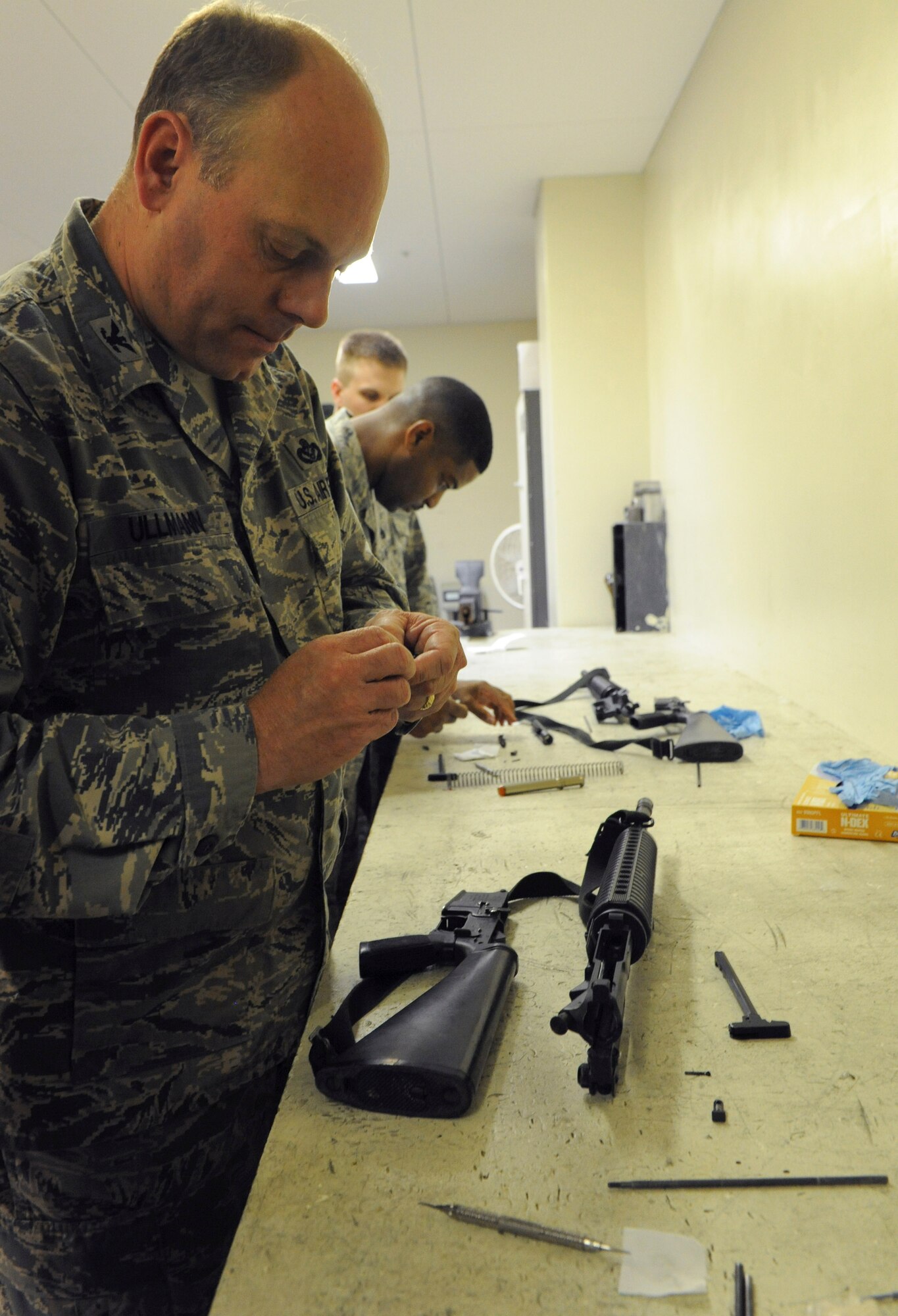 U.S. Air Force Col. Jeff Ullmann, 18th Mission Support Group commander, takes apart a weapon at the 18th Security Forces Squadron on Kadena Air Base, Japan, Feb. 28, 2013. Ullmann was also shown the proper way to receive weapons from security forces members when they return them after a shift. (U.S. Air Force photo/Airman 1st Class Malia Jenkins)