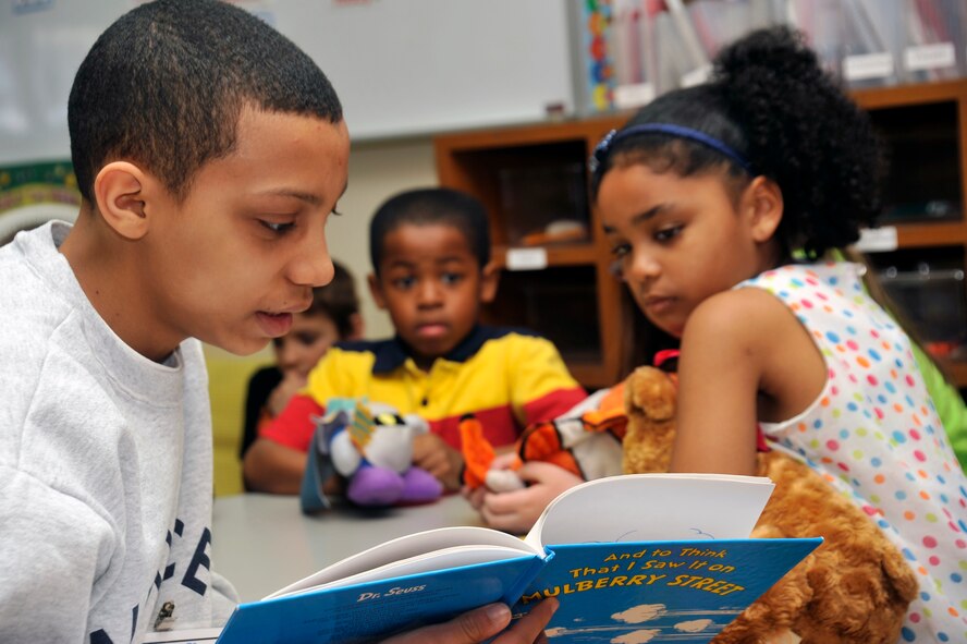 An Edgren High School ninth-grader reads to Cummings Elementary School second-graders at Misawa Air Base, Japan, Feb. 28, 2013. More than 25 Edgren students volunteered to read to students in various classrooms as Cummings celebrated Read Across America Week.  (U.S. Air Force photo by Airman 1st Class Zachary Kee)