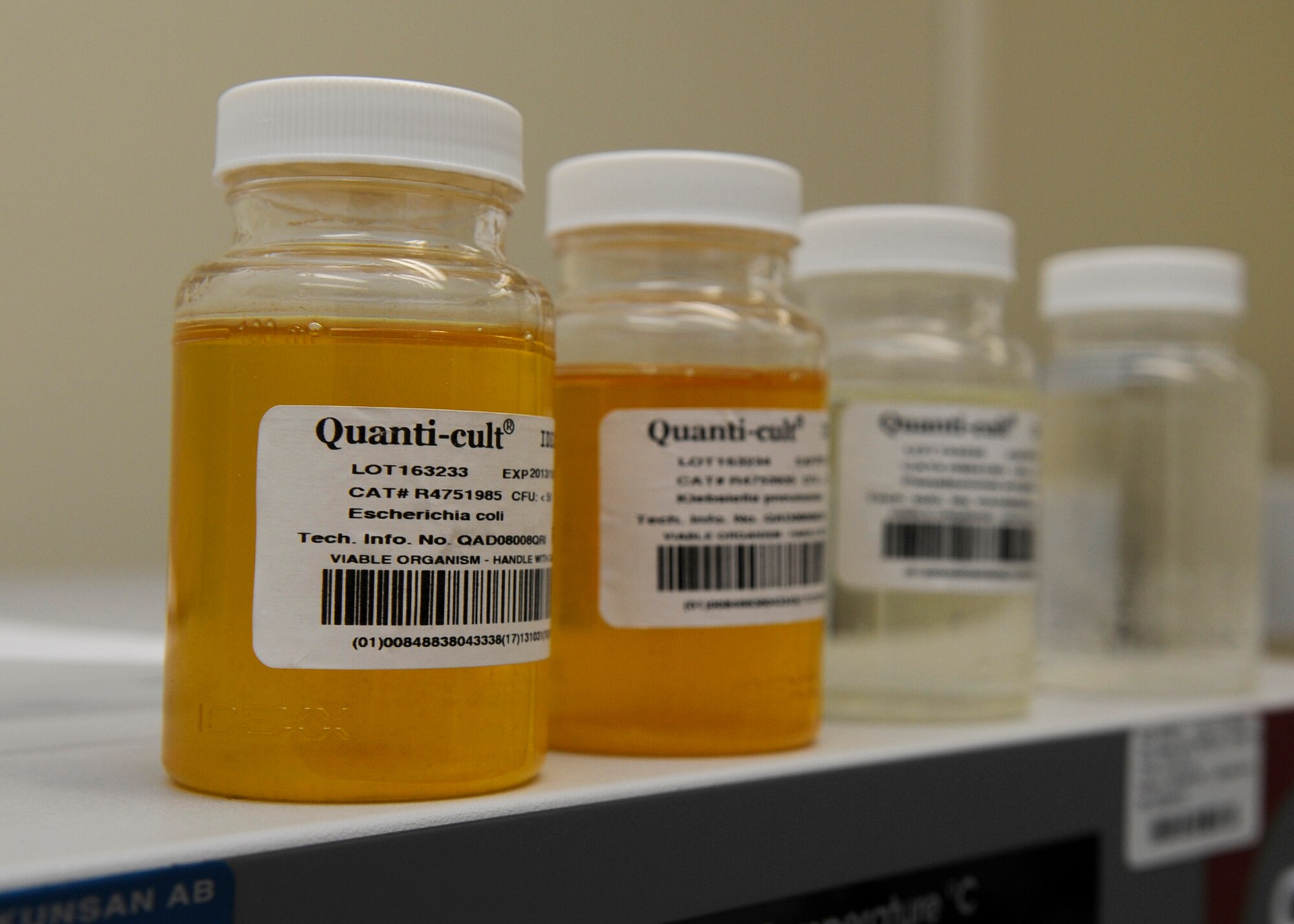 KUNSAN AIR BASE, Republic of Korea – From left: Control water samples containing Escherichia coli (E-coli) and total coli form bacteria, are shown next to two samples with negative traces of bacteria. E-coli bacteria are the best indicator of fecal pollution and the possible presence of pathogens and contaminates. (U.S. Air Force photo Staff Sgt. Tong Duong)