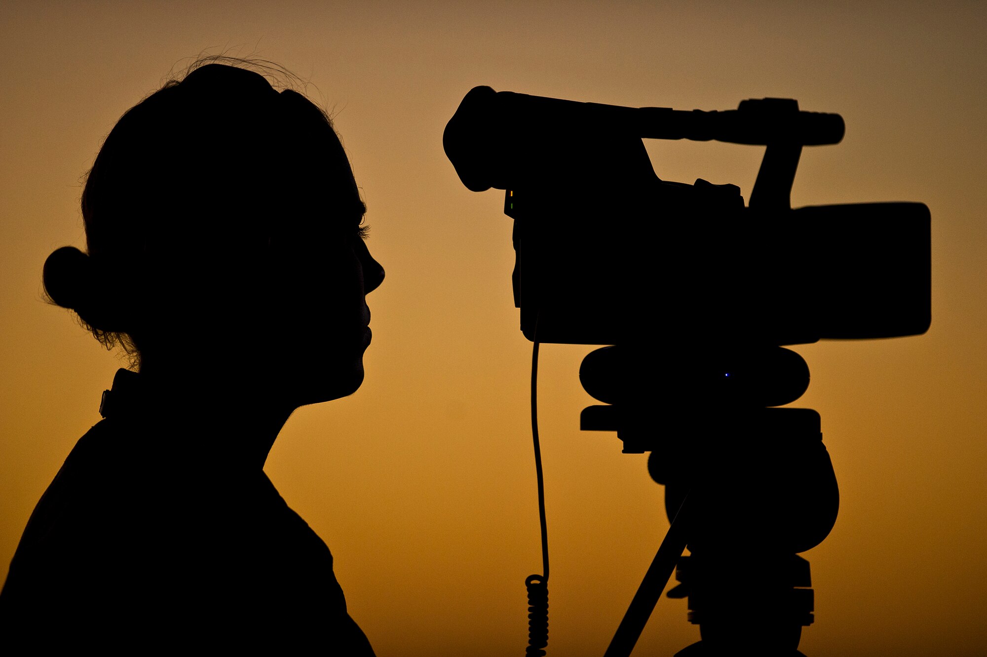 U.S. Air Force Airman 1st Class Ashley Powell, American Forces Network-Pacific broadcast journalist records video as the sun sets for the night performances at the Australian International Airshow, March 1, 2013 at Avalon Airport in Geelong, Australia. Approximately 220 U.S. service members along with the U.S. Air Force's F-22 Raptor, C-17 Globemaster III, F-16 Fighting Falcon, B-52 Stratofortress, and KC-135 Stratotanker are supporting the Australian International Airshow 2013, which allows a unique opportunity for the United States to showcase its aviation prowess and strengthen military-to-military ties with our Pacific allies and partners. (Department of Defense photo by U.S. Air Force Tech. Sgt. Michael R. Holzworth/Released)