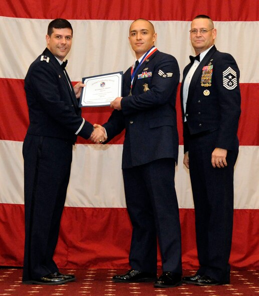 Senior Airman Jimmie Stewart, 2nd Security Forces Squadron, receives an Airman Leadership Graduation certificate from Col. Andrew Gebara, 2nd Bomb Wing commander, on Barksdale Air Force Base, La., Feb. 7. (U.S. Air Force photo/Airman 1st Class Andrew Moua)