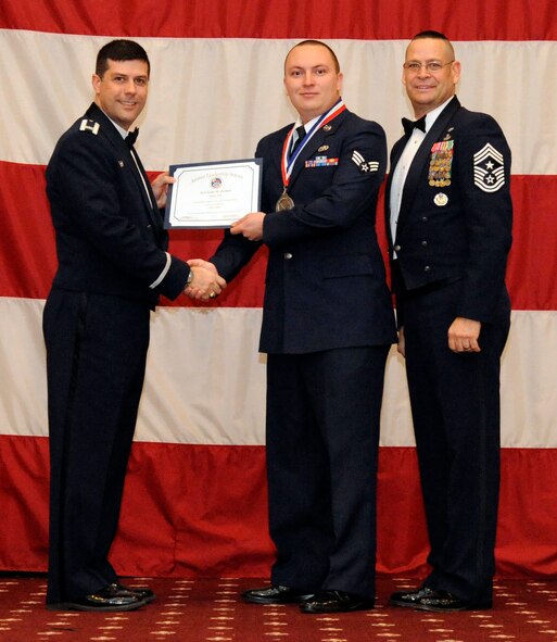 Senior Airman Luke Jordan, 2nd Aircraft Maintenance Squadron, receives an Airman Leadership Graduation certificate from Col. Andrew Gebara, 2nd Bomb Wing commander, on Barksdale Air Force Base, La., Feb. 7. (U.S. Air Force photo/Airman 1st Class Andrew Moua)