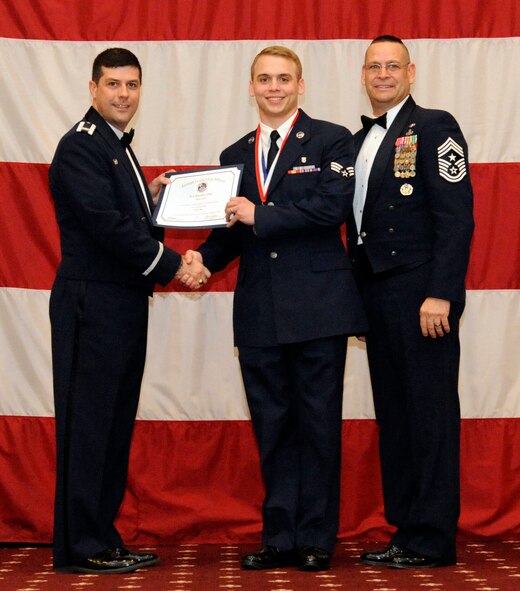 Senior Airman David Eley, 2 nd Medical Support Squadron, receives an Airman Leadership Graduation certificate from Col. Andrew Gebara, 2nd Bomb Wing commander, on Barksdale Air Force Base, La., Feb. 7. (U.S. Air Force photo/Airman 1st Class Andrew Moua)