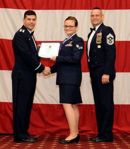 Senior Airman Alisha Smith, 2nd Bomb Wing, receives an Airman Leadership Graduation certificate from Col. Andrew Gebara, 2nd Bomb Wing commander, on Barksdale Air Force Base, La., Feb. 7. (U.S. Air Force photo/Airman 1st Class Andrew Moua)