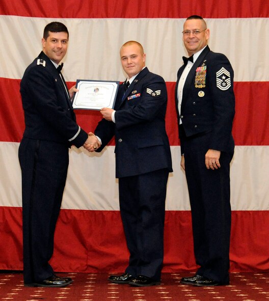 Senior Airman Cody Charlton, 2nd Aircraft Maintenance Squadron, receives an Airman Leadership Graduation certificate from Col. Andrew Gebara, 2nd Bomb Wing commander, on Barksdale Air Force Base, La., Feb. 7. (U.S. Air Force photo/Airman 1st Class Andrew Moua)