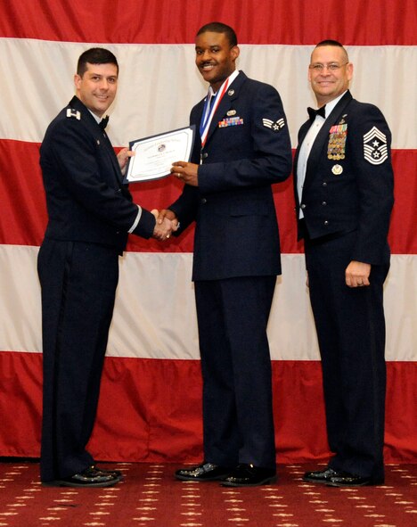 Senior Airman Roderick Burse, 2nd Aircraft Maintenance Squadron, receives an Airman Leadership Graduation certificate from Col. Andrew Gebara, 2nd Bomb Wing commander, on Barksdale Air Force Base, La., Feb. 7. (U.S. Air Force photo/Airman 1st Class Andrew Moua)