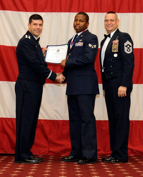 Senior Airman Steven Beckford, 2nd Logistics Readiness Squadron, receives an Airman Leadership Graduation certificate from Col. Andrew Gebara, 2nd Bomb Wing commander, on Barksdale Air Force Base, La., Feb. 7. (U.S. Air Force photo/Airman 1st Class Andrew Moua)
