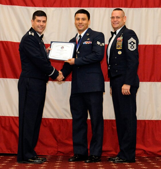Senior Airman Francisco Tapia, 2nd Aircraft Maintenance Squadron, receives an Airman Leadership Graduation certificate from Col. Andrew Gebara, 2nd Bomb Wing commander, on Barksdale Air Force Base, La., Feb. 7. (U.S. Air Force photo/Airman 1st Class Andrew Moua)