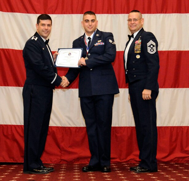 Senior Airman Ryan Hummel, 608th Air Communications Squadron, receives an Airman Leadership Graduation certificate from Col. Andrew Gebara, 2nd Bomb Wing commander, on Barksdale Air Force Base, La., Feb. 7. (U.S. Air Force photo/Airman 1st Class Andrew Moua)