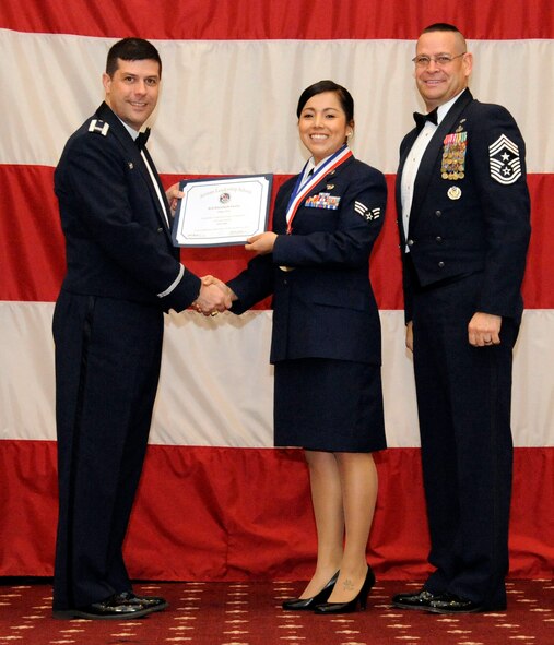 Senior Airman Elizabeth Guinn, 2nd Bomb Wing wing staff agencies, receives an Airman Leadership Graduation certificate from Col. Andrew Gebara, 2nd Bomb Wing commander, on Barksdale Air Force Base, La., Feb. 7. (U.S. Air Force photo/Airman 1st Class Andrew Moua)