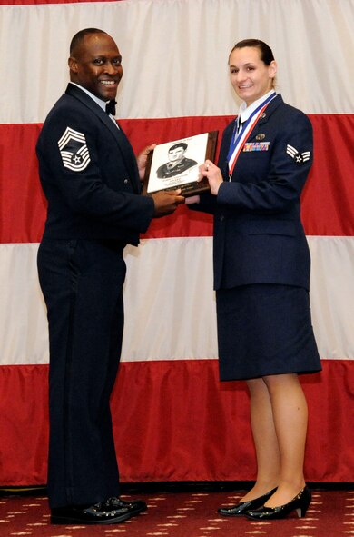 Senior Airman Felicia Logsdon, 2nd Comptroller Squadron, receives the John L. Levitow Award from Chief Master Sgt. Richard Rhodes, Air Force Global Strike Command, during the Airman Leadership School Class 13-2 Graduation on Barksdale Air Force Base, La., Feb. 7. (U.S. Air Force photo/Airman 1st Class Andrew Moua)