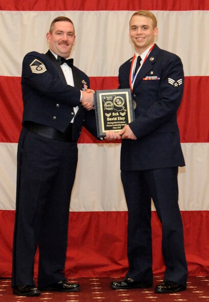 Senior Airman David Eley, 2nd Medical Support Squadron, receives the Distinguished Graduate Award from Master Sgt. Jason Hurley, Air Force Global Strike Command, during the Airman Leadership School Class 13-2 Graduation on Barksdale Air Force Base, La., Feb. 7. (U.S. Air Force photo/Airman 1st Class Andrew Moua)