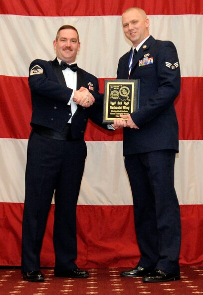 Senior Airman Nathaniel Wing, 2nd Munitions Squadron, receives the Distinguished Graduate Award from Master Sgt. Jason Hurley, Air Force Global Strike Command, during the Airman Leadership School Class 13-2 Graduation on Barksdale Air Force Base, La., Feb. 7. (U.S. Air Force photo/Airman 1st Class Andrew Moua)