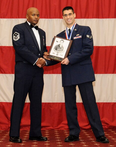 Senior Airman Mark Moceri, 2nd Aircraft Maintenance Squadron, receives the Commandants Award from Master Sgt. Donel Graham during the Airman Leadership School Class 13-2 Graduation on Barksdale Air Force Base, La., Feb. 7. (U.S. Air Force photo/Airman 1st Class Andrew Moua)