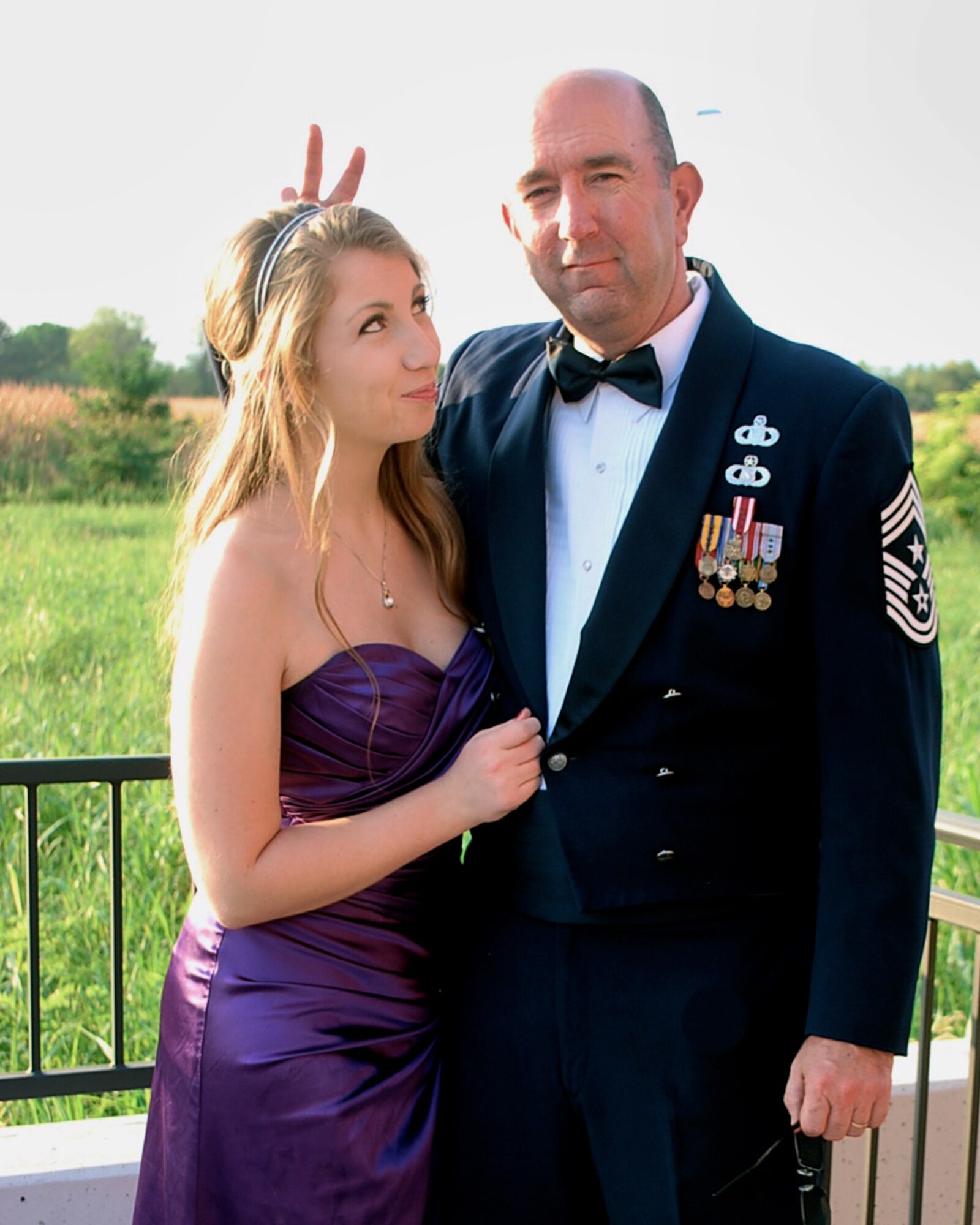 Chief Master Sgt. Jeffrey Craver, 31st Fighter Wing command chief, jokes around with his daughter on the porch of his house. For 18 years, his daughter has associated the military uniform with that of safety, security, dignity, trust and respect. However, with more than 700 sexual assaults reported across the Air Force in 2012, the uniform can be a fearful reminder that their brothers or sisters in arms assaulted them. (Courtesy Photo)