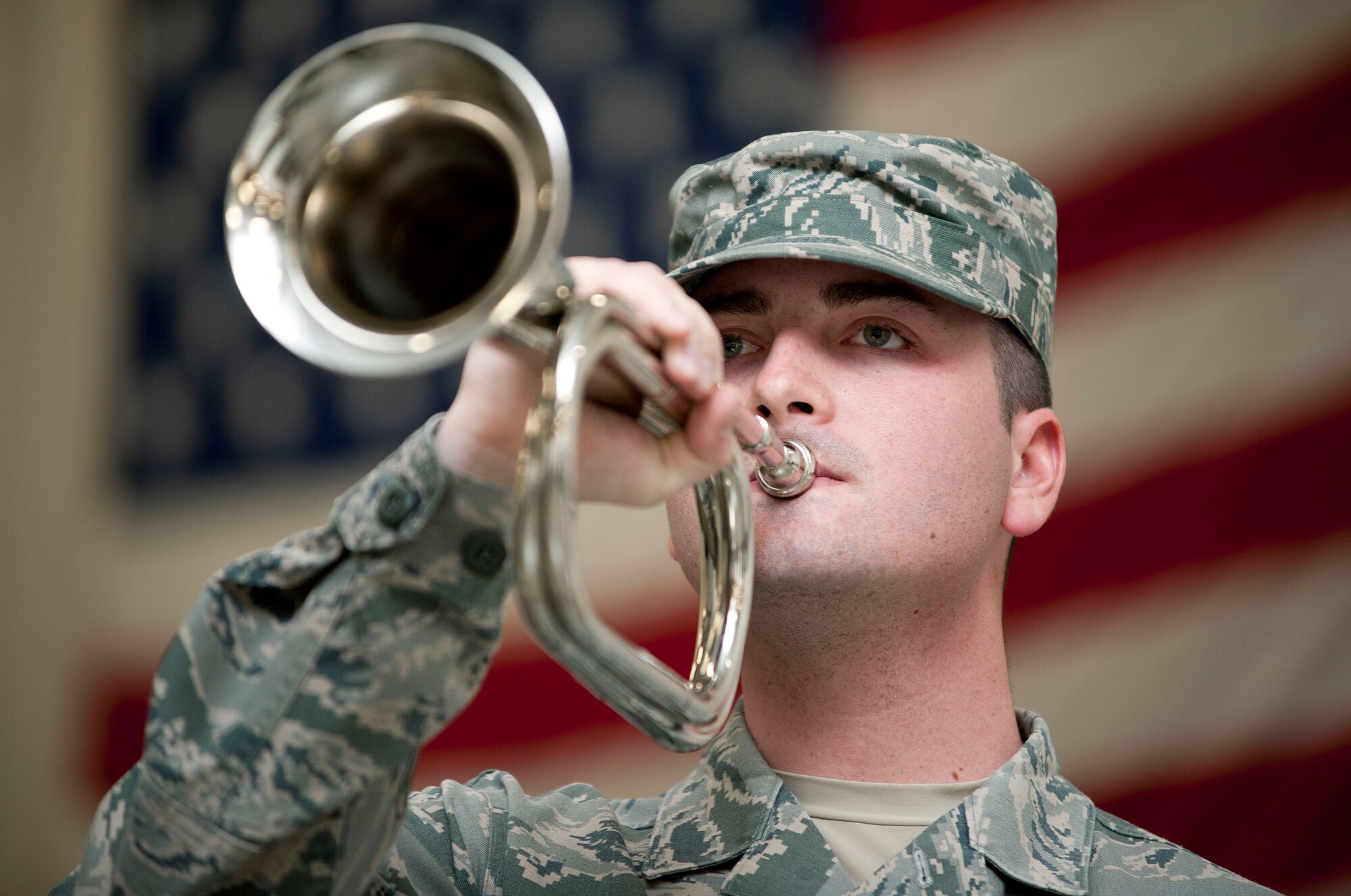 Airman 1st Class Michael Holley, 22 Air Refueling Wing Base Honor Guard bugler, plays taps at a standard honor guard funeral practice March 4, 2013, McConnell Air Force Base, Kan. During the ceremony, taps is played right before the American flag is presented to the next of kin. (U.S. Air Force photo/Airman 1st Class Jarrod M. Vickers)
