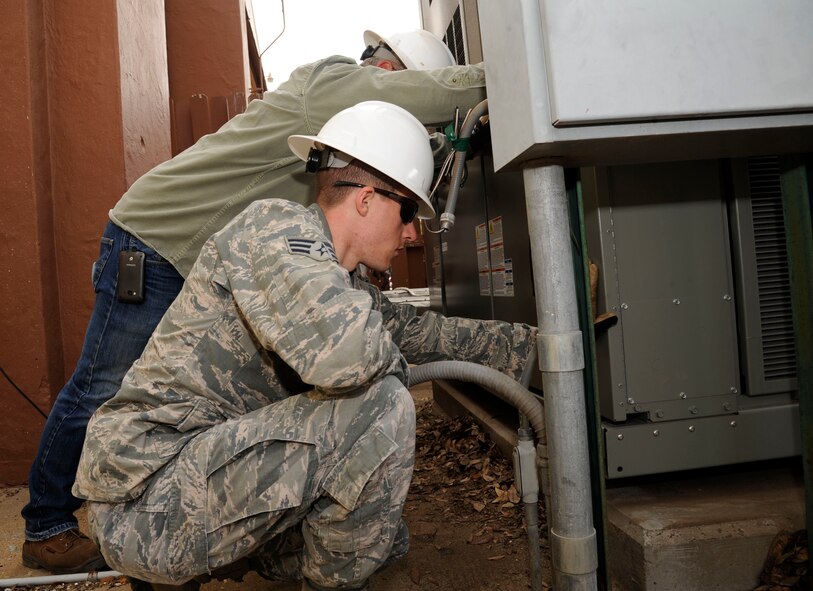 Senior Airman Brian Stanyer, 2nd Civil Engineer Squadron Heating, Ventilation, Air Conditioning and Refrigeration, helps stabilize a chiller during installation on Barksdale Air Force Base, La., March 1. Responsibilities of HVAC/R Airmen include climate control for buildings and maintenance and repair of heating and cooling units. (U.S. Air Force photo/Airman 1st Class Andrew Moua)