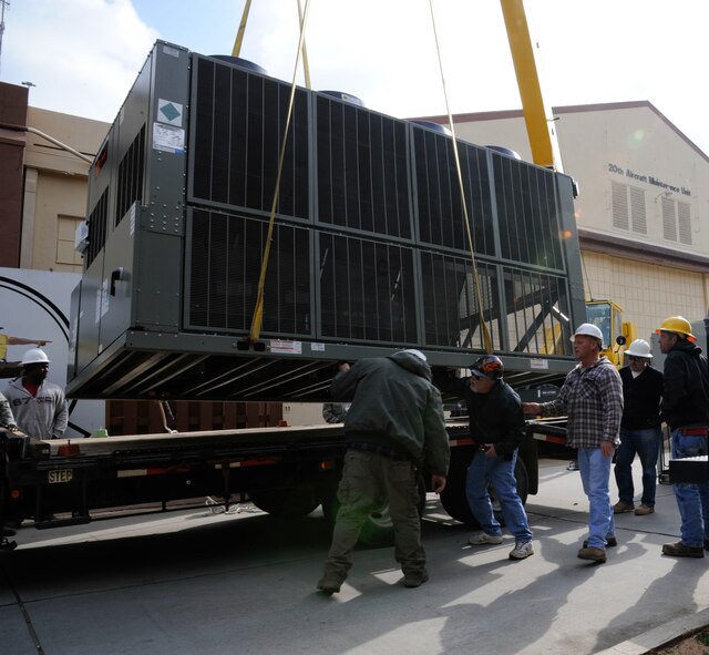 Workers assigned to the 2nd Civil Engineer Squadron Heavy Repair section, inspect a chilling unit prior to installation on Barksdale Air Force Base, La., March 1. The heavy repair section worked with the 2 CES heating, ventilation, air conditioning and refrigeration section to remove an old air conditioning unit and replace it with a new one. (U.S. Air Force photo/Airman 1st Class Andrew Moua)