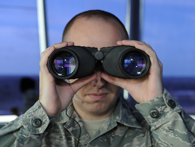 Senior Airman Patrick Shattlerly, 2nd Operations Support Squadron Air Traffic Controller, looks through binoculars on Barksdale Air Force Base, La., March 4. Air Traffic Controllers monitor flightline operations 24/7 and stay vigilant in ensuring mission success. (U.S. Air Force photo/Airman 1st Class Benjamin Gonsier) 