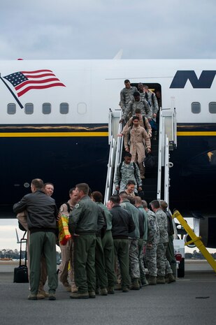 Returning members of the 14th Airlift Squadron exit the commercial plane which flew them home during the 14th AS redeployment March 3, 2013, at Joint Base Charleston - Air Base, S.C. More than 100 Airmen from the 14th AS returned home from a 120-day deployment to Southwest Asia. (U.S. Air Force photo/ Senior Airman George Goslin)