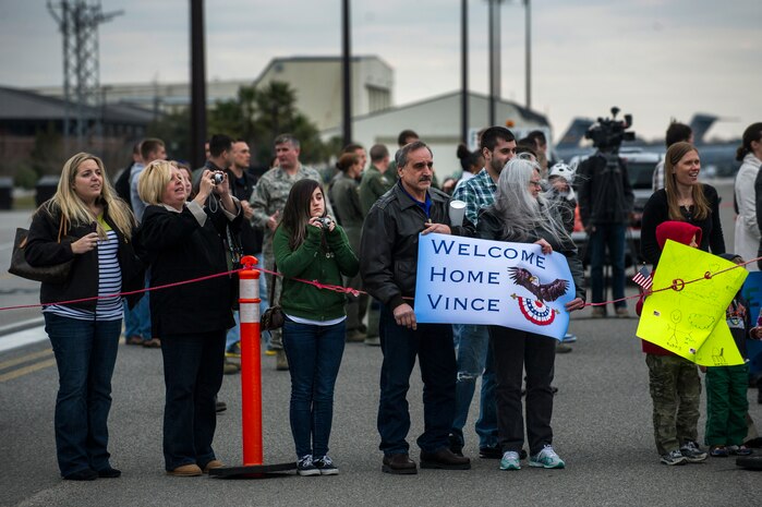 The family of Airman 1st Class Vince Denisi, 14th Airlift Squadron loadmaster, waits for him to exit the plane during the 14th AS re-deployment March 3, 2013, at Joint Base Charleston - Air Base, S.C. More than 100 Airmen from the 14th AS returned home from a 120-day deployment to Southwest Asia. (U.S. Air Force photo/ Senior Airman George Goslin)