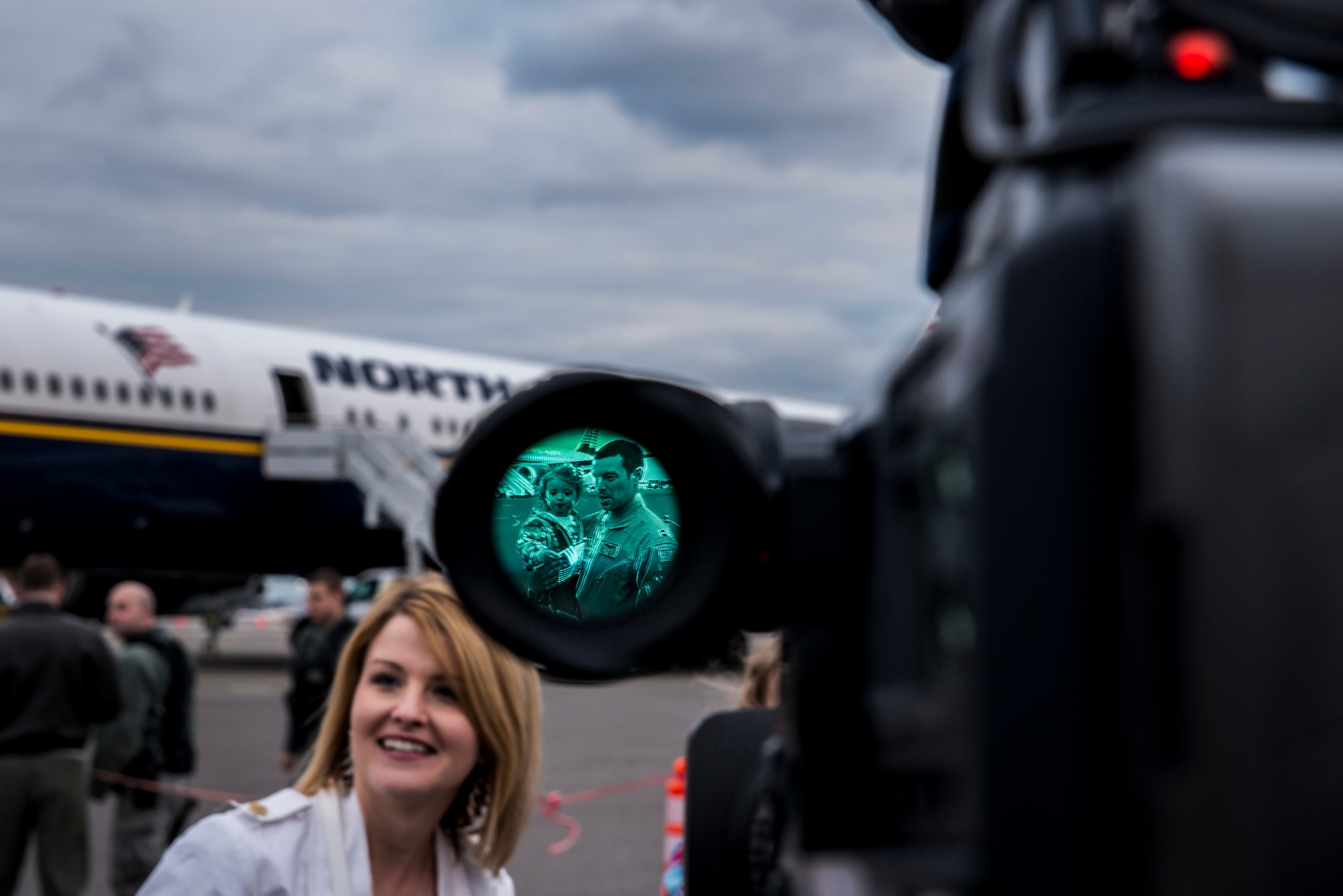 Emily Crane and Capt. Daniel Crane, 14th Airlift Squadron pilot, take part in an interview with local media during the 14th AS redeployment March 3, 2013, at Joint Base Charleston - Air Base, S.C. More than 100 Airmen from the 14th AS returned home from a 120-day deployment to Southwest Asia. (U.S. Air Force photo/ Senior Airman George Goslin)