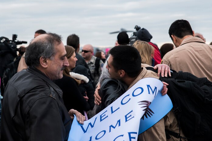 Airman 1st Class Vince Denisi, 14th Airlift Squadron loadmaster, hugs his mother during the 14th AS redeployment March 3, 2013, at Joint Base Charleston - Air Base, S.C. More than 100 Airmen from the 14th AS returned home from a 120-day deployment to Southwest Asia. (U.S. Air Force photo/ Senior Airman George Goslin)