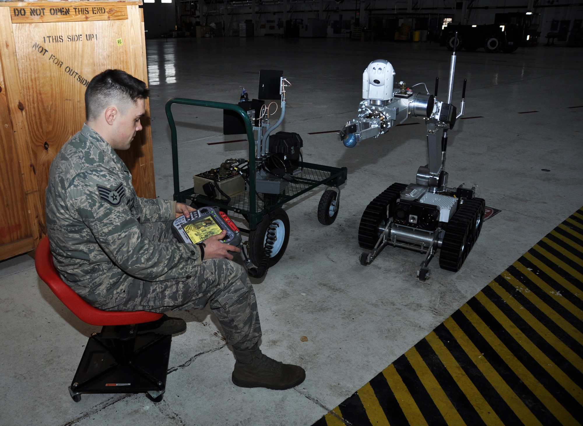 NIAGARA FALLS AIR RESERVE STATION, N.Y.-- Staff Sgt. Jason Berg, 914th Civil Engineering Squadron, demonstrates a new Explosive Ordnance Device robot programmed to handle potentially explosive devices, March 3, 2013. (U.S. Air Force photo by Staff Sgt. Stephanie Clark) 