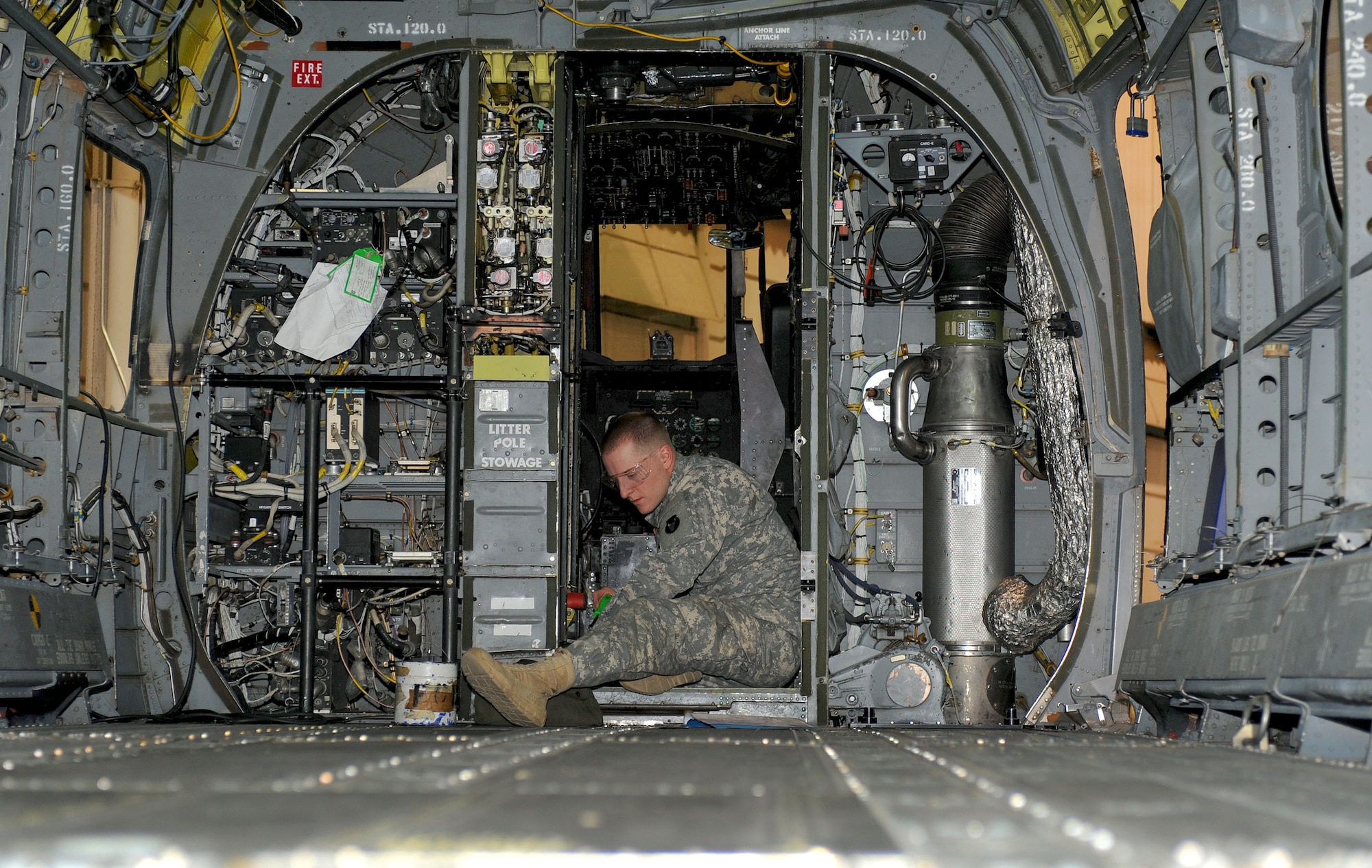 U.S. Army Pvt. Dustin Westpool, an Advanced Individual Training student assigned to the 2nd Battalion, 210th Aviation Regiment, repairs CH-47 Chinook FH controls during a class at Fort Eustis, Va., Feb. 20, 2013. The battalion is divided into three companies – A, B and C – that specialize in training on particular airframes and components. (U.S. Air Force photo by Staff Sgt. Ashley Hawkins/Released) 