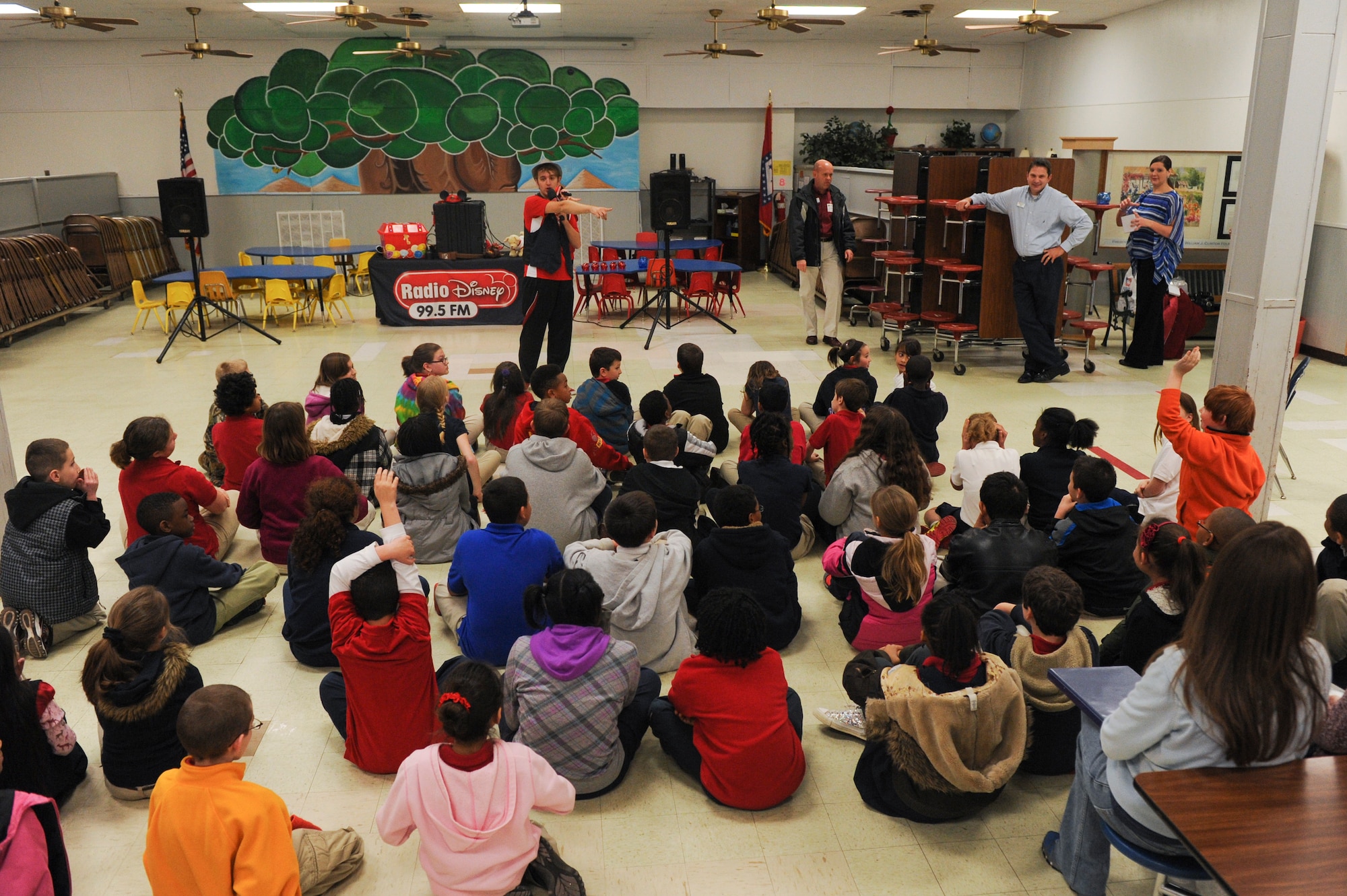 A Radio Disney performer talks to students from Arnold Drive Elementary, during Military Saves Week Feb. 28, 2013, at Little Rock Air Force Base, Ark. During the event, students danced to musical numbers and were taught the importance of saving money. (U.S. Air Force photo by Senior Airman Rusty Frank)