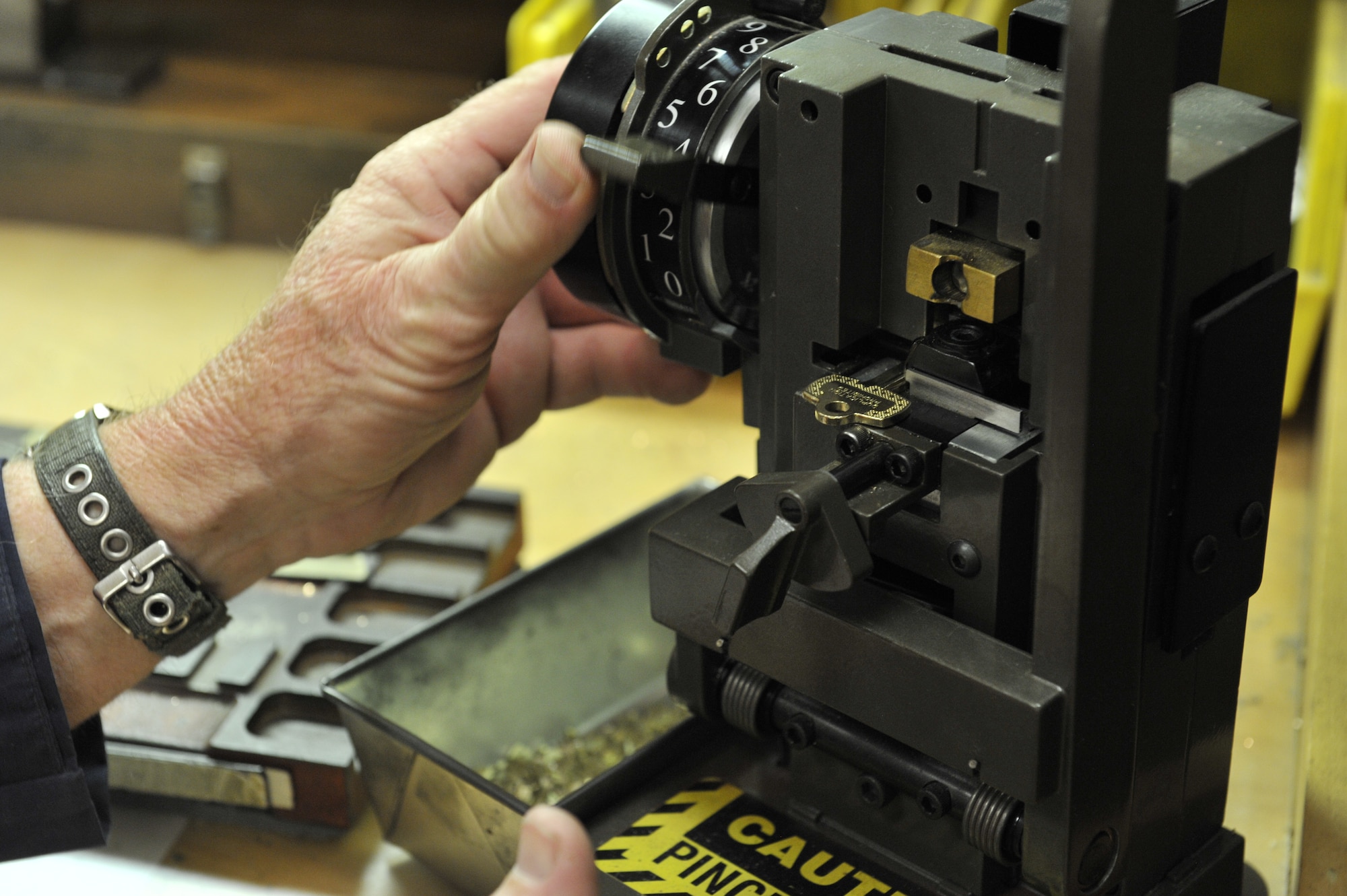 Robert Scott, 20th Civil Engineer Squadron locksmith, demonstrates how to create a brand new key, Shaw Air Force Base, S.C., March 1, 2013. Scott has worked at Shaw as a locksmith since 1995 after he retired from the Air Force in 1990. (U.S. Air Force photo by Senior Airman Amber E. N. Jacobs/Released)