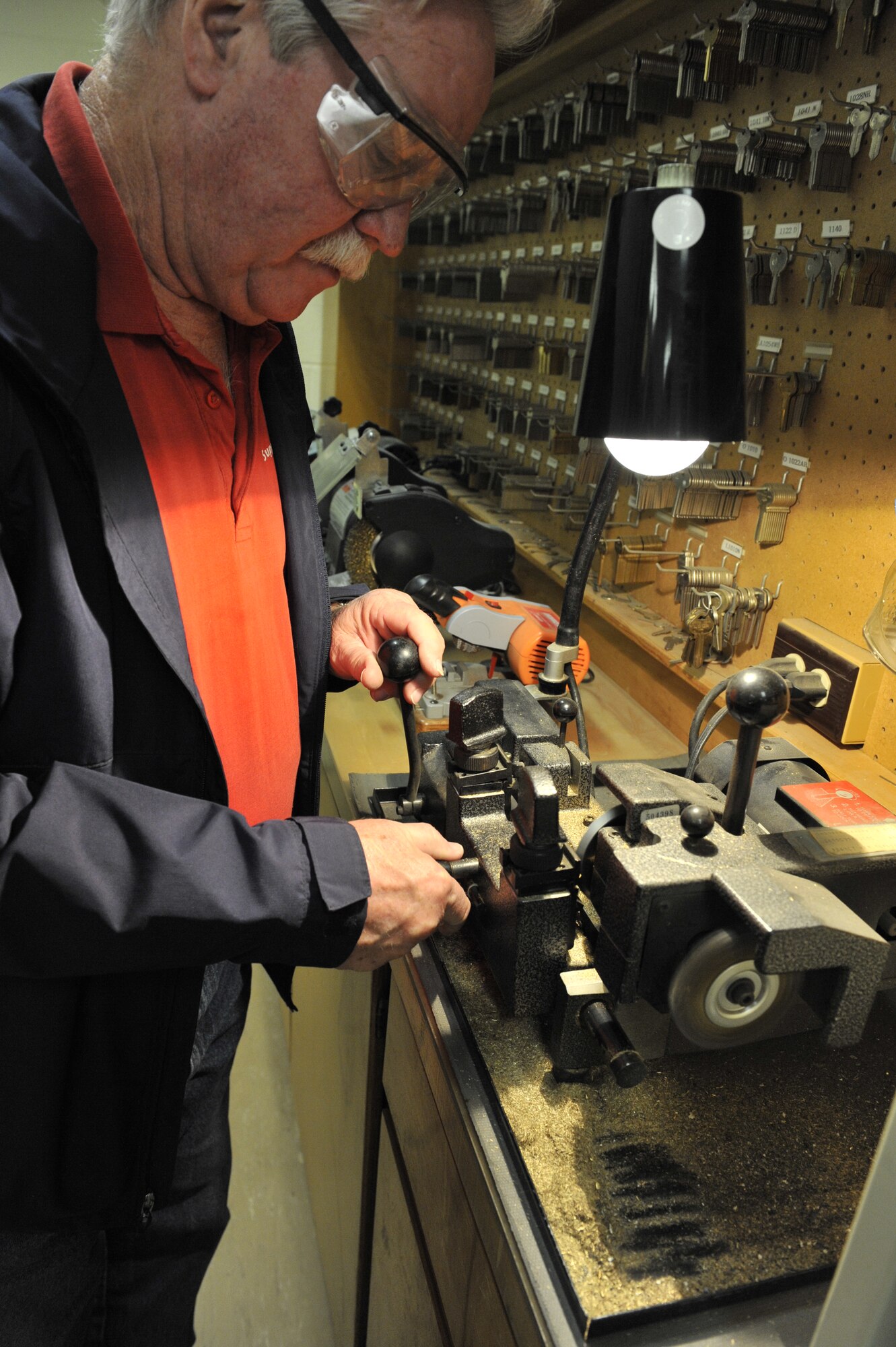 Robert Scott, 20th Civil Engineer Squadron locksmith, uses a machine that duplicates old keys, Shaw Air Force Base, S.C., March 1, 2013. Scott is the only locksmith at Shaw and is responsible for maintaining all of the base locks. Scott retired as a master sergeant from the Air Force in 1990 as a tactical air control party member. (U.S. Air Force photo by Senior Airman Amber E. N. Jacobs/Released)




