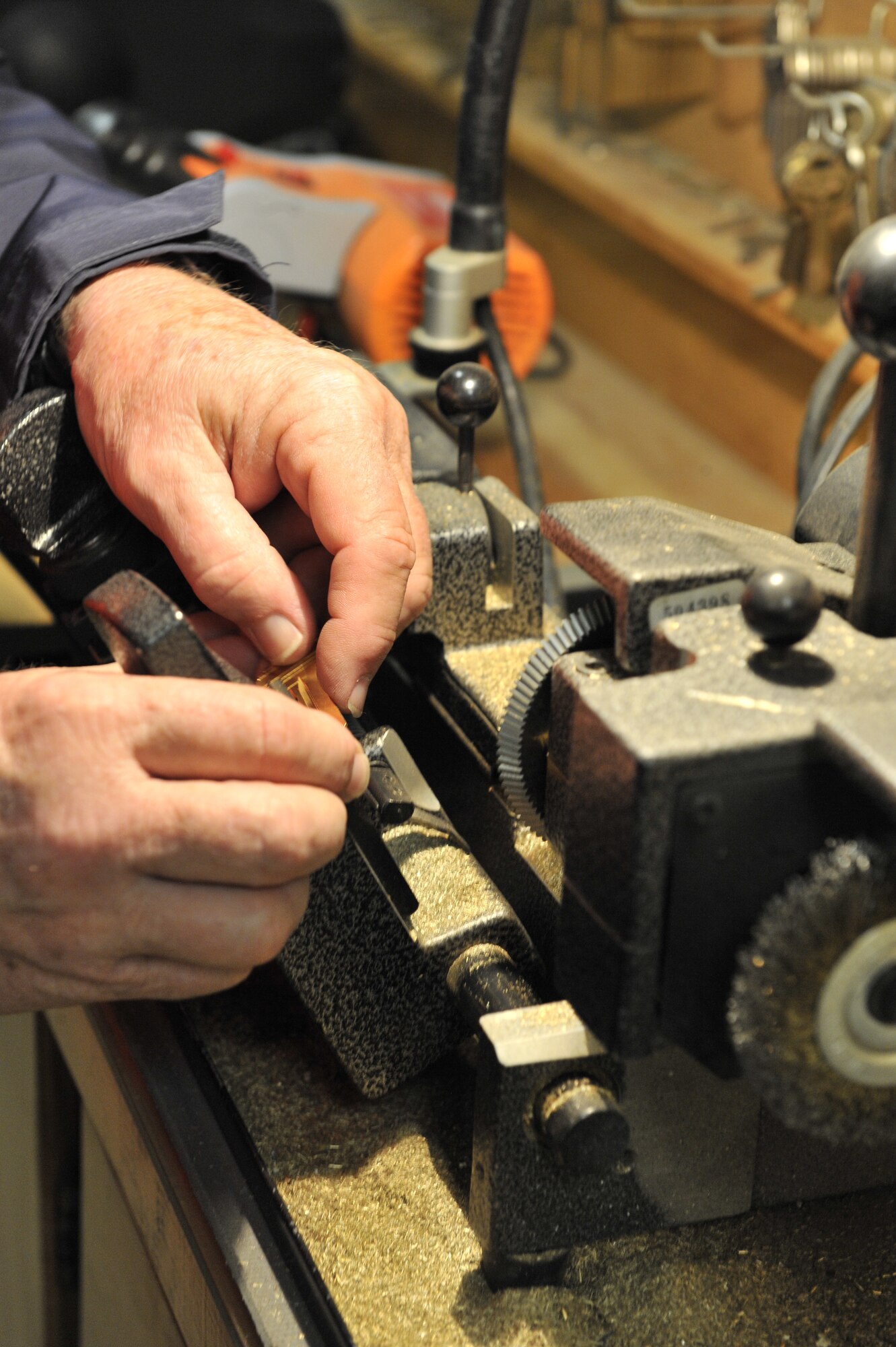Robert Scott, 20th Civil Engineer Squadron locksmith, loads a key into a machine that duplicates old keys, Shaw Air Force Base, S.C., March 1, 2013. Scott is the only locksmith at Shaw and is responsible for maintaining all of the base locks. (U.S. Air Force photo by Senior Airman Amber E. N. Jacobs/Released)




