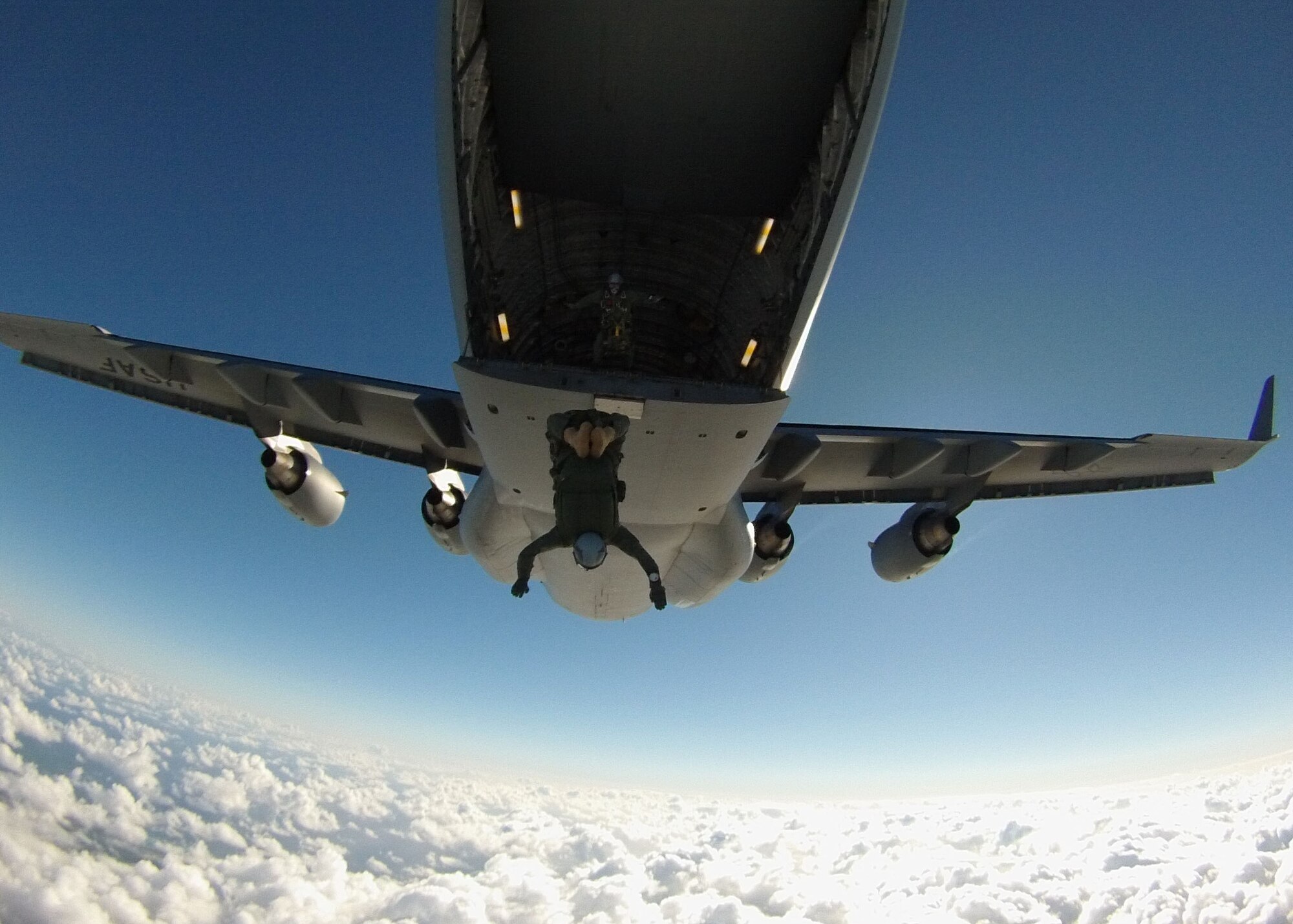 Maj. Aaron Lawson, Special Operations Command, Pacific jumper and special tactics officer, jumps from a C-17 Globemaster III near Joint Base Pearl Harbor Hickam-Hawaii, Feb. 26, 2013. The jump was filmed by veteran freefall cameraman and skydiver cinematographer, Tom Sanders, and will be used in a scene on an upcoming episode of the television show “Hawaii Five-0.” Lawson was recently given the opportunity to serve as a stunt double for actor Alex O’Loughlin, who plays Steve McGarrett on the show, and will be featured alongside U.S. Marine Corps Staff Sgt. John Phillips, SOCPAC jumper and parachute rigger, performing the freefall jump. (Photo by Tom Sanders)