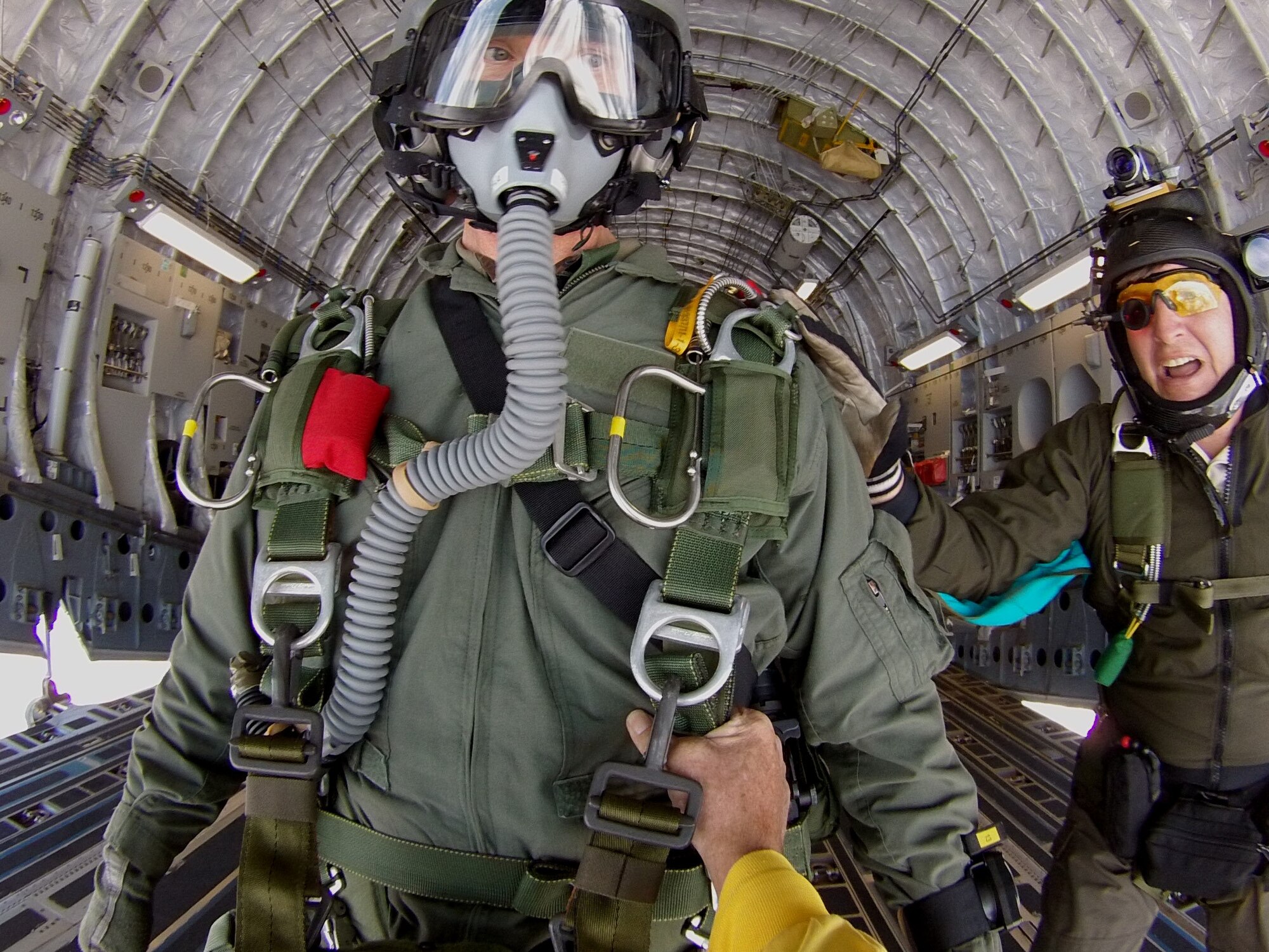 Maj. Aaron Lawson, Special Operations Command, Pacific jumper and special tactics officer, (left) gets the green light for a jump from  James Menne, chief of training and readiness for SOCPAC, (right) and Tom Sanders, veteran freefall cameraman and skydiver cinematographer, (not pictured) just before exiting a C-17 Globemaster III near Joint Base Pearl Harbor Hickam-Hawaii, Feb. 26, 2013. Sanders was on hand to film the jump as part of an upcoming scene for television show “Hawaii Five-0,” in which the SOCPAC jumpers will serve as stunt doubles for the show’s actors. Sanders exited the plane just before Lawson in order to capture the jump in its entirety. (Photo by Tom Sanders)