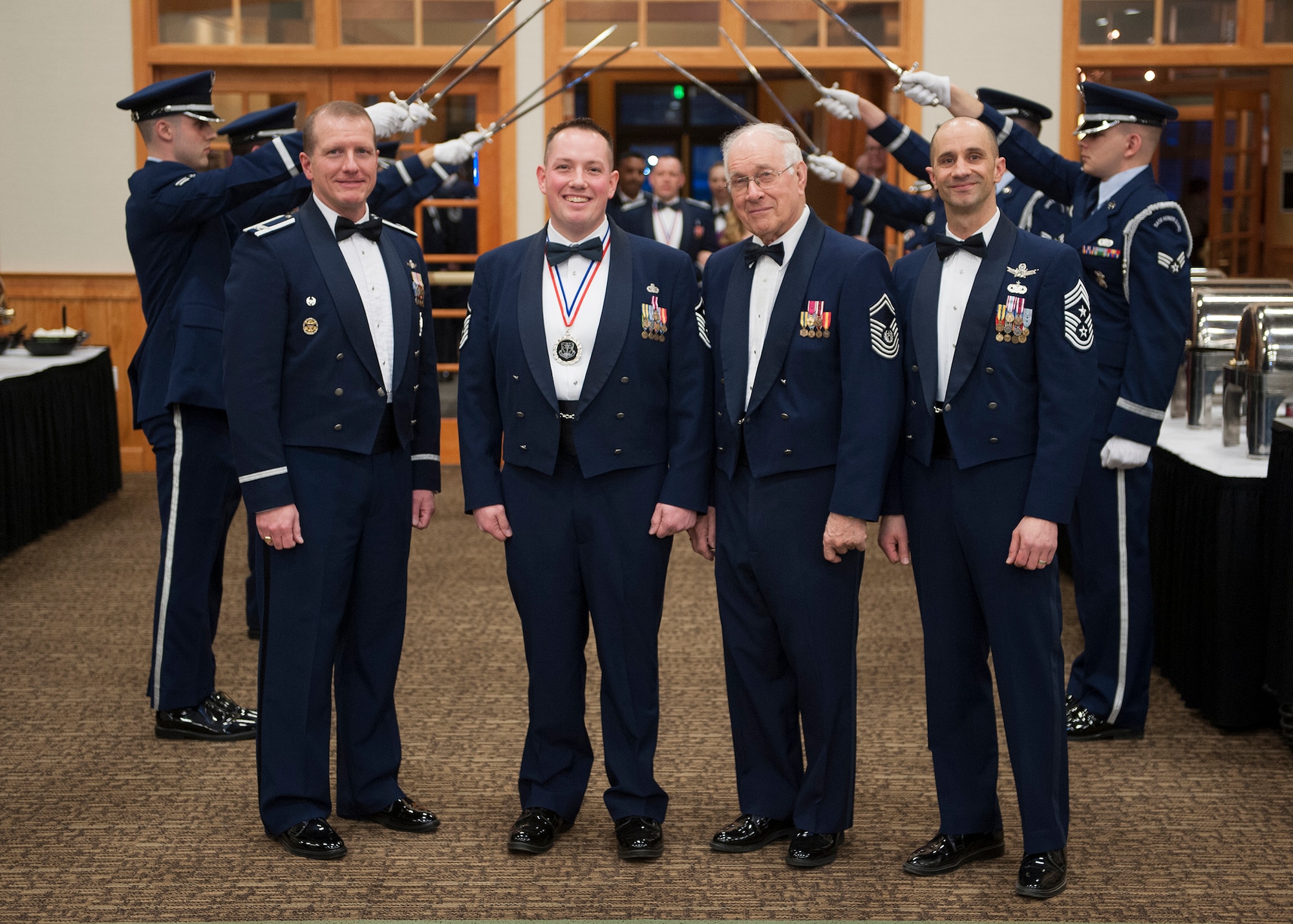 (From left) Col. Robert Stanley, 341st Missile Wing commander; Master Sgt. Collin Crandall, 341st Civil Engineer Squadron first sergeant; 8th Chief Master Sgt. of the Air Force, Sam Parish; and Chief Master Sgt. Frank Fidani, 341st MW command chief, pose for a photograph at the annual awards Banquet held Feb. 22 at the Grizzly Bend. (U.S. Air Force photo/ Beau Wade)