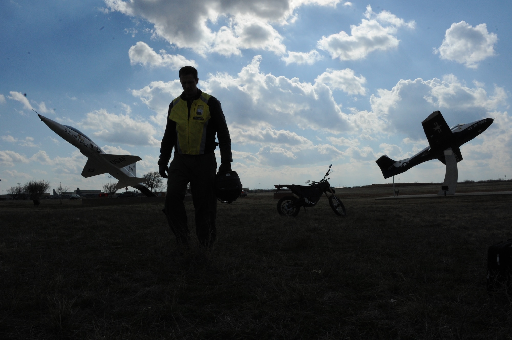 Lt .Col. Frank Arnold of the 80th Commander’s Action Group finishes driving his bike through a field near the 80th Operations Group building March 1, 2013. Arnold utilizes his bike to cut down on the amount of energy his vehicular transportation uses. (U.S. Air Force photo by Airman First Class Jelani Gibson)