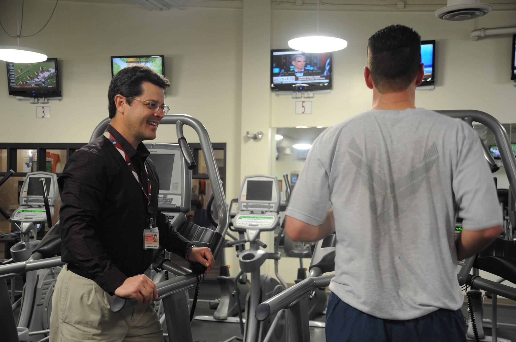 Brian Todd, a Health Promotion Educator at the Health and Wellness Center, coaches a runner Feb. 27, 2013. Todd is tasked with helping his clients develop better running habits. (U.S. Air Force photo by Airman First Class Jelani Gibson)