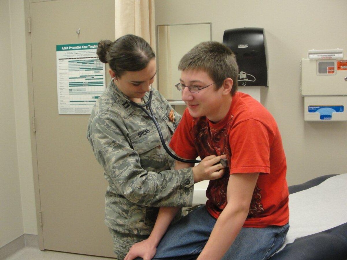 Capt. Erin Brown, 21st Medical Group family nurse practitioner and a member of Team Ajax, one of six PCMH teams in the Peterson Family Health Clinic, provides care to one of her enrollees. (U.S. Air Force photo)
