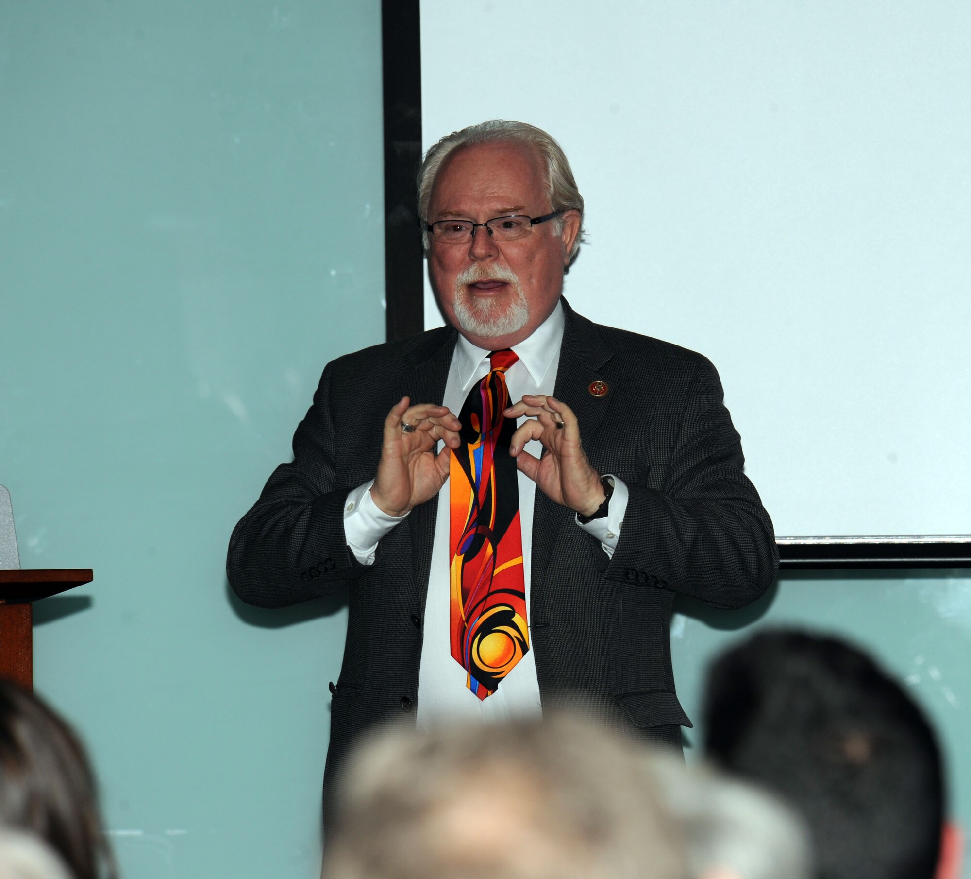 Congressman Ron Barber shows off his "solar" tie during the 60th Solar 101 at the Wilmot-Murphy Branch Library in Tucson, Ariz., Feb. 19, 2013. Barber wore the tie, which was a gift from Gabrielle Giffords, for the first time in honor of the 60th Solar 101. (U.S. Air Force photo by Senior Airman Timothy Moore/Released)